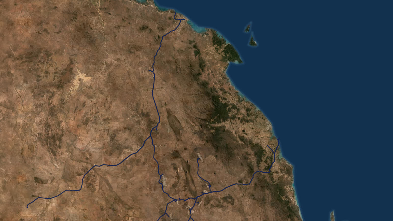 Satellite view of a bulk rail network running from inland mines to a coastal port